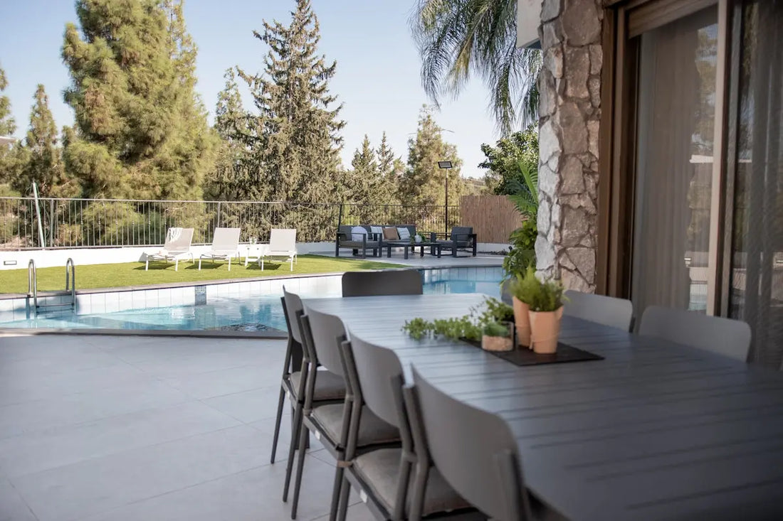 Outdoor dining table and chairs by a swimming pool